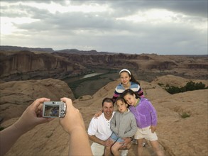 Father and daughters having photograph taken. Date : 2007