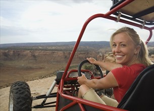 Woman in off-road vehicle at edge of cliff. Date : 2007