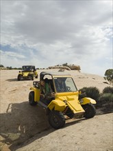 People in off-road vehicles on rock formation. Date : 2007