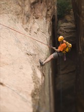 Man in rappelling gear at top of cliff. Date : 2007