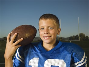 Young football player holding ball. Date : 2007
