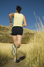Woman running on trail, Utah, United States. Date : 2007