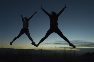 Silhouette of people jumping, Salt Flats, Utah, United States. Date : 2007