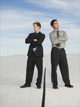 Businessmen on opposite sides of line, Salt Flats, Utah, United States. Date : 2007