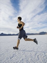 Man running on salt flats, Utah, United States. Date : 2007
