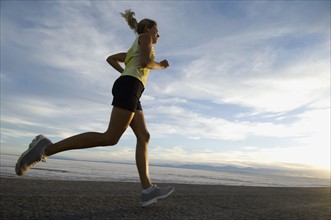 Woman running on road, Utah, United States. Date : 2007