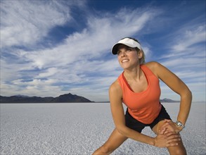 Woman stretching at salt flats, Utah, United States. Date : 2007