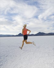 Woman running on salt flats, Utah, United States. Date : 2007