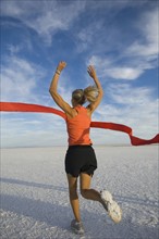 Woman running across finish line, Utah, United States. Date : 2007