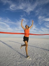 Woman running across finish line, Utah, United States. Date : 2007