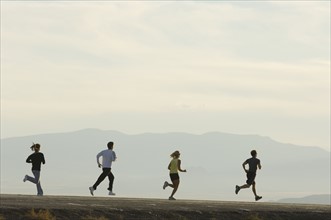Group of people running on road, Utah, United States. Date : 2007