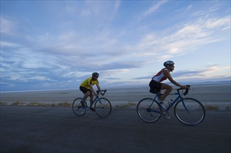Couple cycling on road, Utah, United States. Date : 2007