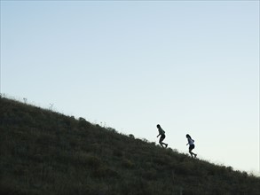 People running up mountain, Salt Flats, Utah, United States. Date : 2007
