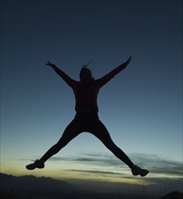 Silhouette of women jumping, Salt Flats, Utah, United States. Date : 2007