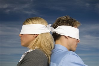 Blindfolded businesspeople standing back to back, Salt Flats, Utah, United States. Date : 2007