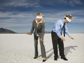 Blindfolded businesspeople on salt flats, Salt Flats, Utah, United States. Date : 2007