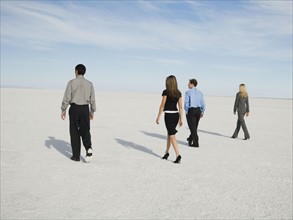 Businesspeople walking on salt flats, Salt Flats, Utah, United States. Date : 2007