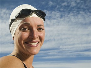 Woman wearing swimming cap and goggles, Utah, United States. Date : 2007