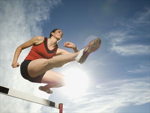 Female athlete jumping hurdle, Utah, United States. Date : 2007