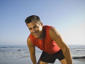 Man in athletic gear at beach. Date : 2007