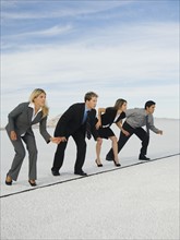 Businesspeople at starting line for race, Salt Flats, Utah, United States. Date : 2007