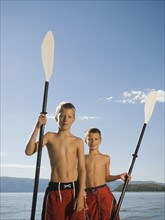 Brothers holding canoe paddles, Utah, United States. Date : 2007