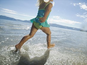 Girl running in water, Utah, United States. Date : 2007