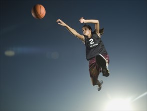 Girl jumping with basketball. Date : 2007