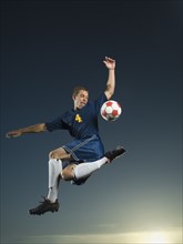 Man kicking soccer ball in air. Date : 2007