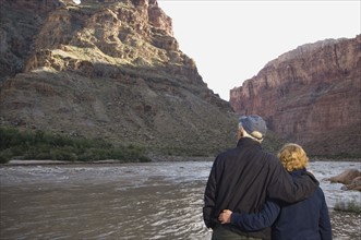 Couple looking at river, Colorado River, Moab, Utah, United States. Date : 2007
