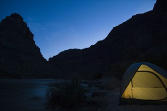 Tent next to river at night, Colorado River, Moab, Utah, United States. Date : 2007