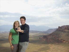 Couple taking own photograph. Date : 2007