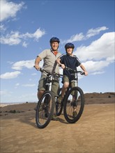 Portrait of father and son on mountain bikes. Date : 2007