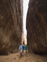 People hiking between rock formations. Date : 2007