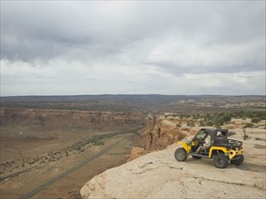 People in off-road vehicle at edge of cliff. Date : 2007