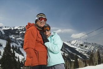 Couple in ski gear hugging. Date : 2007