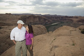 Couple smiling at each other on rock formation. Date : 2007