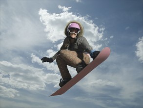 Low angle view of snowboarder jumping. Date : 2007