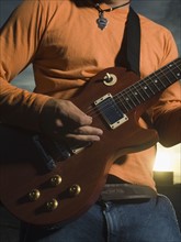 Close up of man playing guitar. Date : 2007