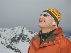 Man wearing earbuds in mountains. Date : 2007