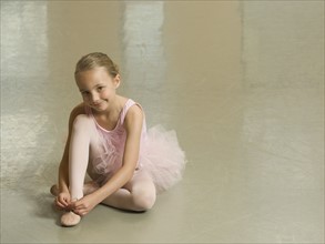 Girl tying ballet shoe. Date : 2007