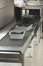 Airport security worker checking baggage. Date : 2007