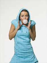 Woman blowing bubble with gum. Date : 2007