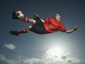 Low angle view of soccer player jumping. Date : 2007