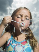 Young girl blowing bubble. Date : 2007