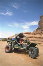 Man driving off-road vehicle in desert. Date : 2007