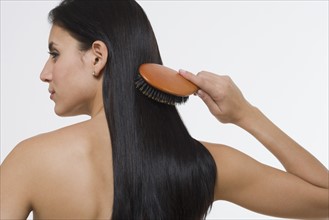 Woman brushing hair.