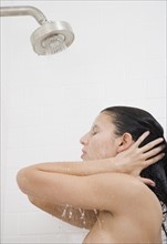 Woman standing under shower.