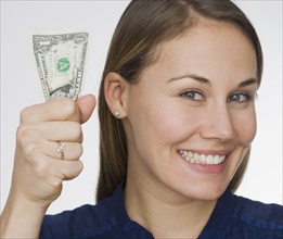 Woman holding dollar bill.
