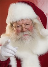 Portrait of Santa Claus pointing.